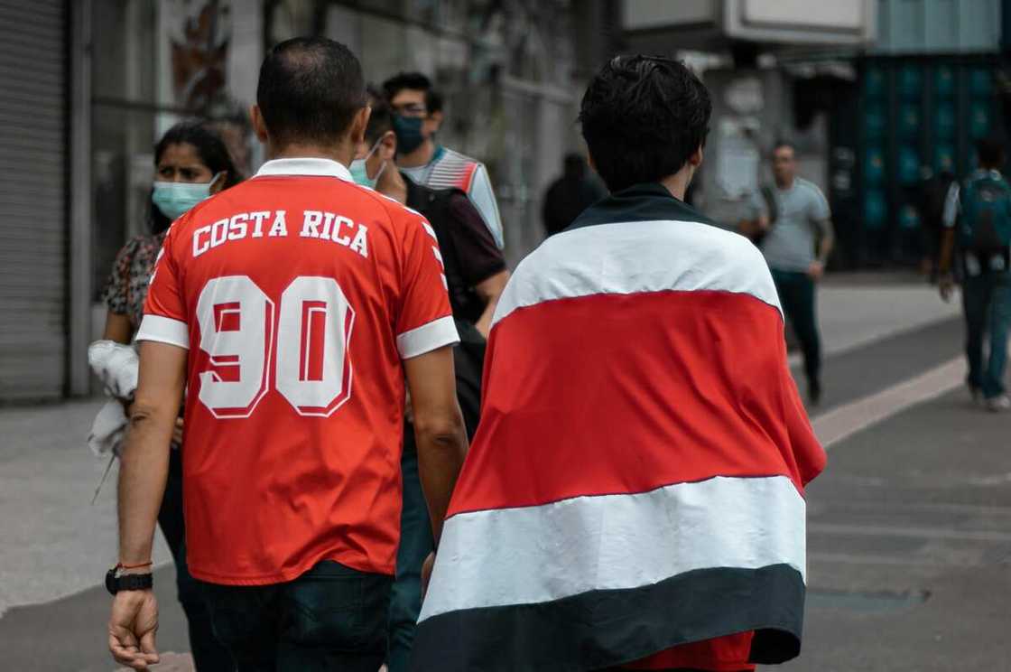 Costa Rica football fans walking on the sidewalk