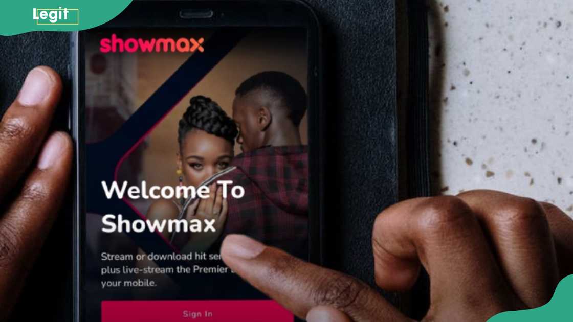 A phone showing Showmax sign in page A phone showing Showmax sign in page