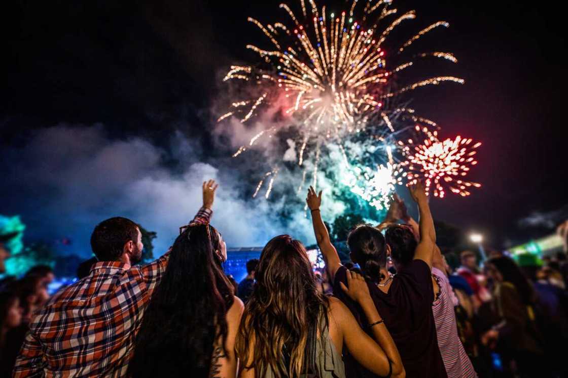 A large group of people watching fireworks on the sky