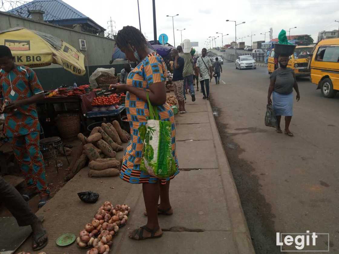 A buyer, checking out the cost price of onion on display at a market in Lagos state. Photo credit: Esther Odili A buyer, checking out the cost price of onion on display at a market in Lagos state. Photo credit: Esther Odili