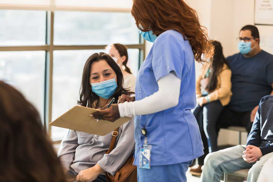 A healthcare worker is talking with a patient A healthcare worker is talking with a patient