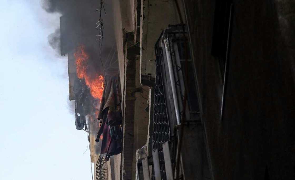 Flames pour out of a blazing building in Gaza City following an Israeli air strike Flames pour out of a blazing building in Gaza City following an Israeli air strike