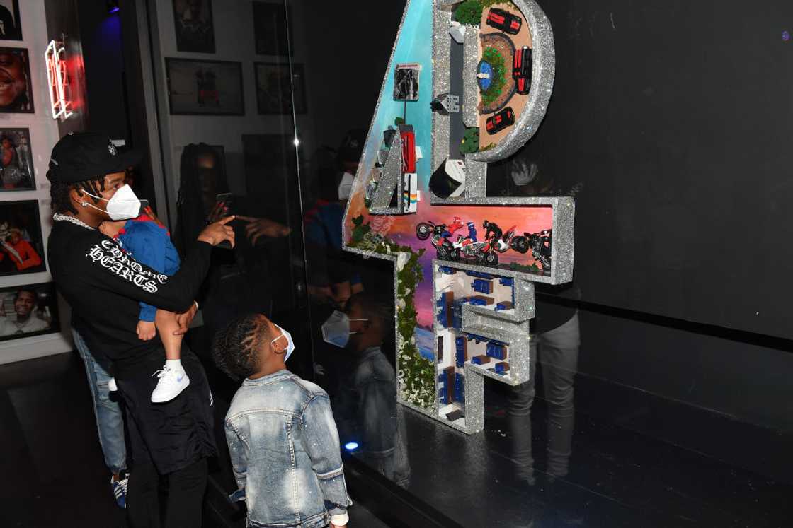 Lil Baby and his sons visit his "Trapper of the Year" Exhibit