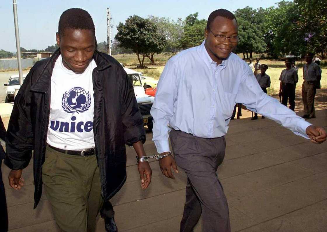 Job Sikhala, right, is handcuffed to fellow opposition MP Tafadzwa Musekiwa as they head into court in 2000 for allegedly threatening to use violence to overthrow the government. The case was dismissed Job Sikhala, right, is handcuffed to fellow opposition MP Tafadzwa Musekiwa as they head into court in 2000 for allegedly threatening to use violence to overthrow the government. The case was dismissed