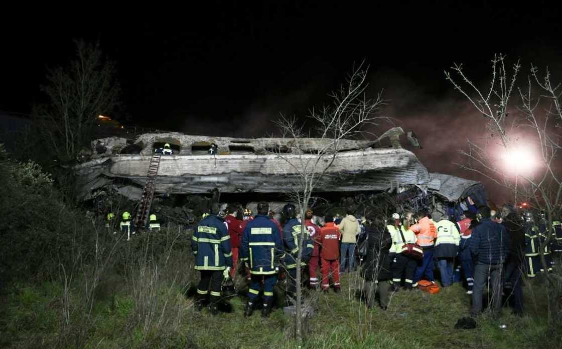Several carriages were almost completely destroyed in the collision between a passenger train and a freight train Several carriages were almost completely destroyed in the collision between a passenger train and a freight train