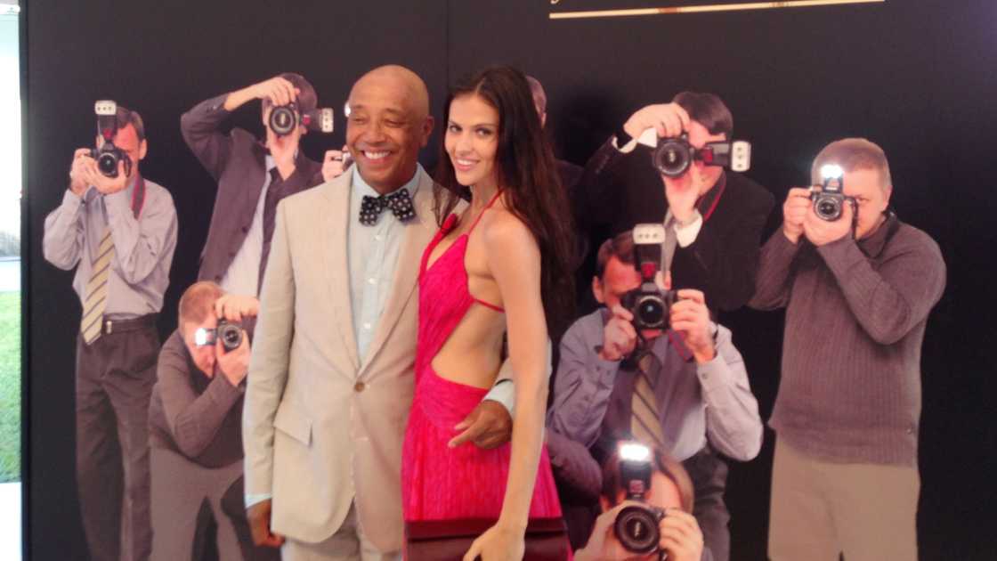 Russell Simmons and model Hana Nitsche pose at the Roberto Cavalli-Cristiano Mancini Art For Life Gala in New York City.