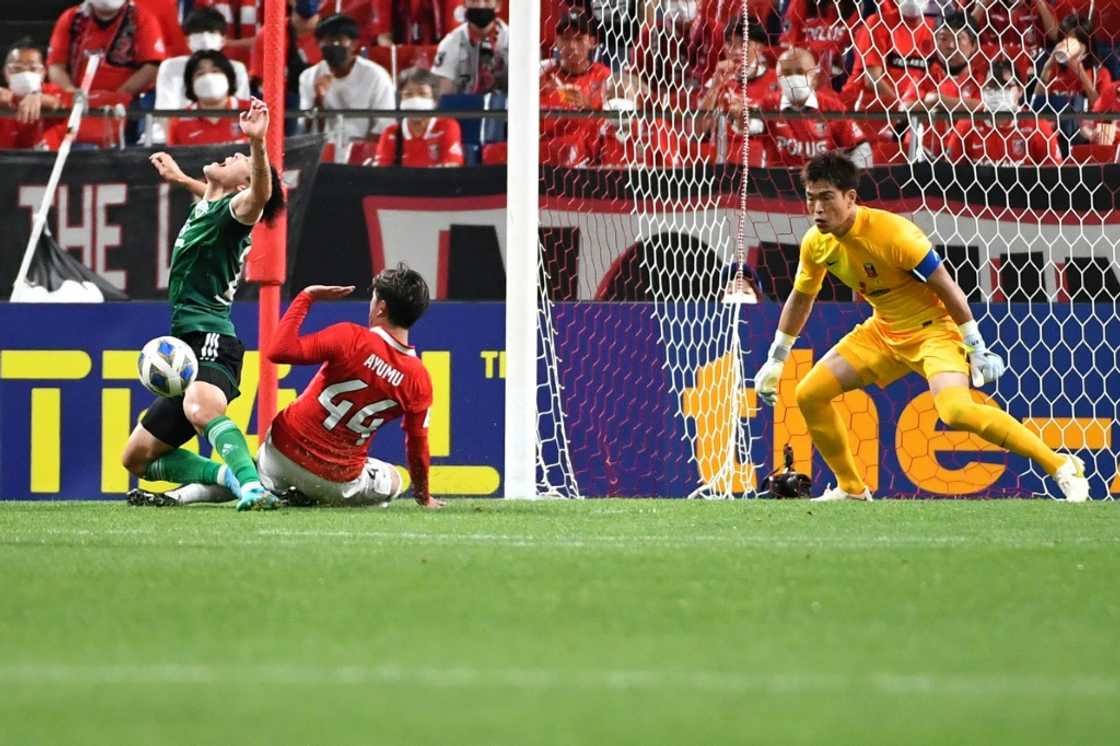 Jeonbuk's Korean forward Song Min-kyu is fouled in the box Jeonbuk's Korean forward Song Min-kyu is fouled in the box