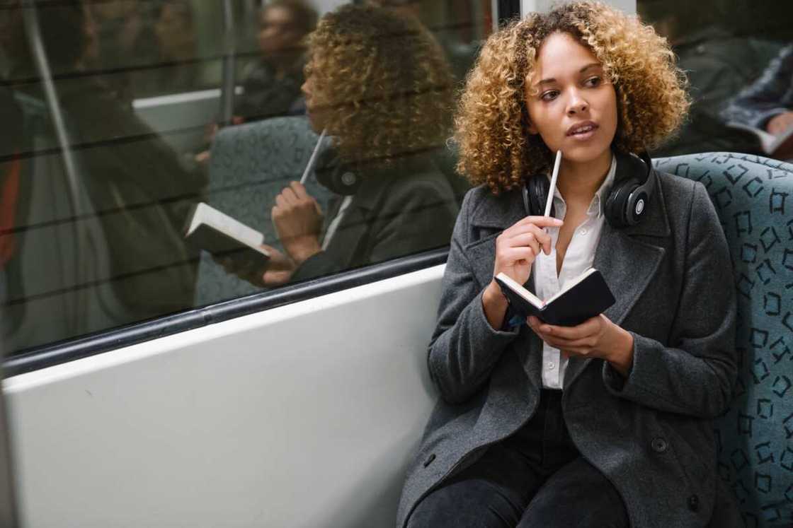 Woman taking notes on a subway Woman taking notes on a subway