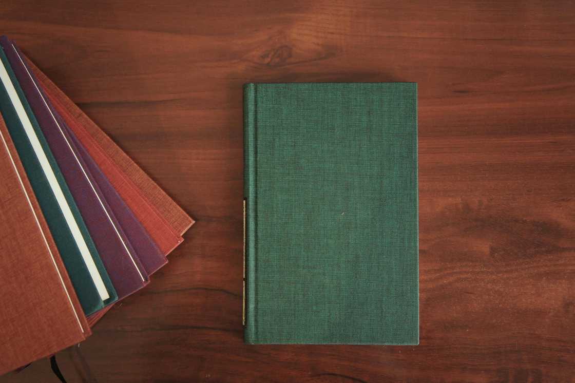 Several journals on a wooden table