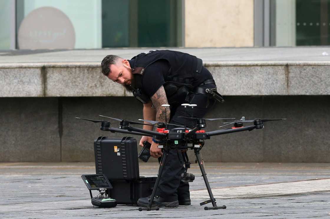 A Police officer uses a drone as he works outside the Arndale Centre shopping complex in Manchester, northwest England on October 11, 2019, following a series of stabbings. Police arrested a man on terror charges Friday after a mass stabbing at a shopping centre in Manchester, northwest England, that left five people injured. The man in his 40s was "lunging and attacking people" with a large knife in the Arndale shopping centre, Police Chief Russ Jackson said. The suspect was detained within five minutes and initially arrested for assault, before this was changed to an accusation of preparing and instigating an act of terrorism. A Police officer uses a drone as he works outside the Arndale Centre shopping complex in Manchester, northwest England on October 11, 2019, following a series of stabbings. Police arrested a man on terror charges Friday after a mass stabbing at a shopping centre in Manchester, northwest England, that left five people injured. The man in his 40s was "lunging and attacking people" with a large knife in the Arndale shopping centre, Police Chief Russ Jackson said. The suspect was detained within five minutes and initially arrested for assault, before this was changed to an accusation of preparing and instigating an act of terrorism.