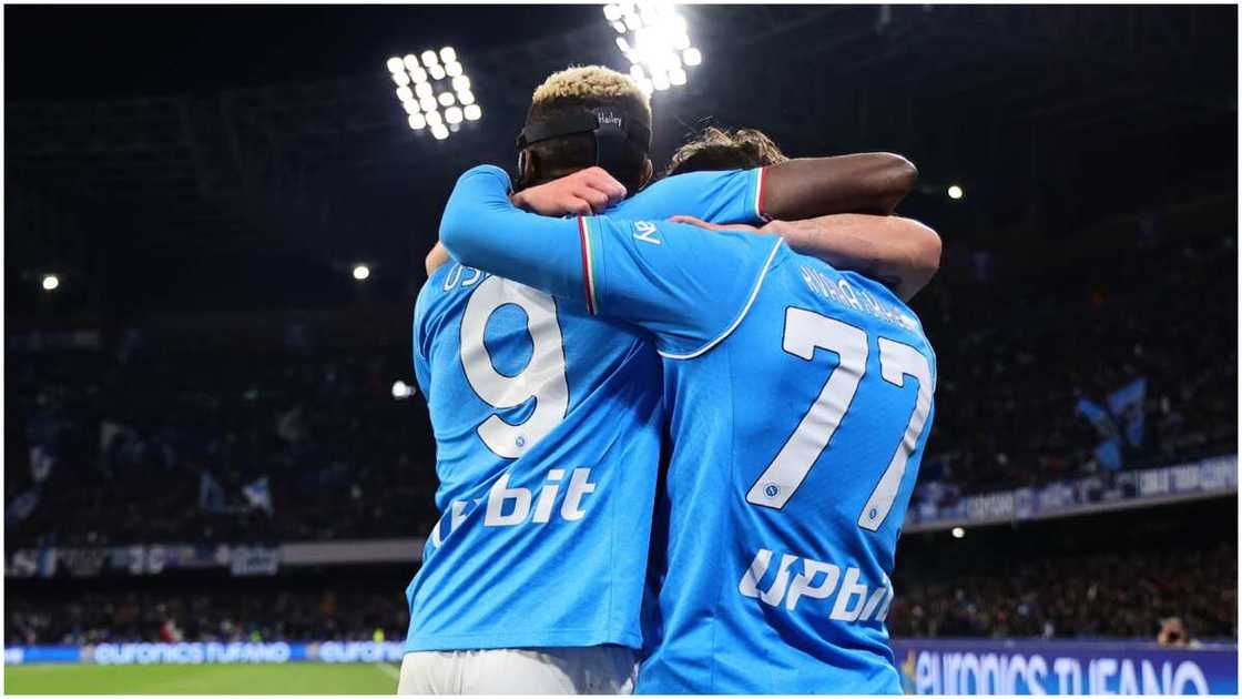 Victor Osimhen and Khvicha Khvarastkelia embrace during a Napoli match.