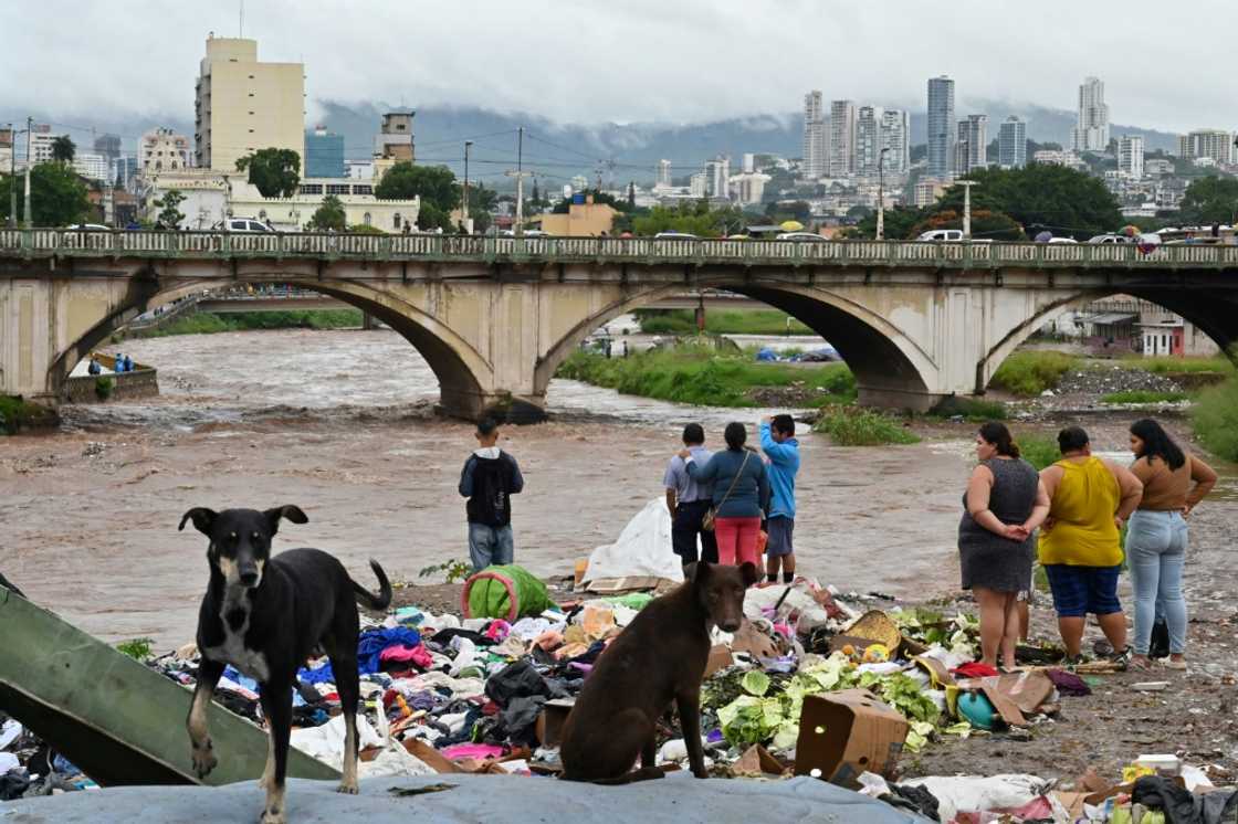 People look at the flooding of the Choluteca river in Tegucigalpa, Honduras, on November 17, 2024