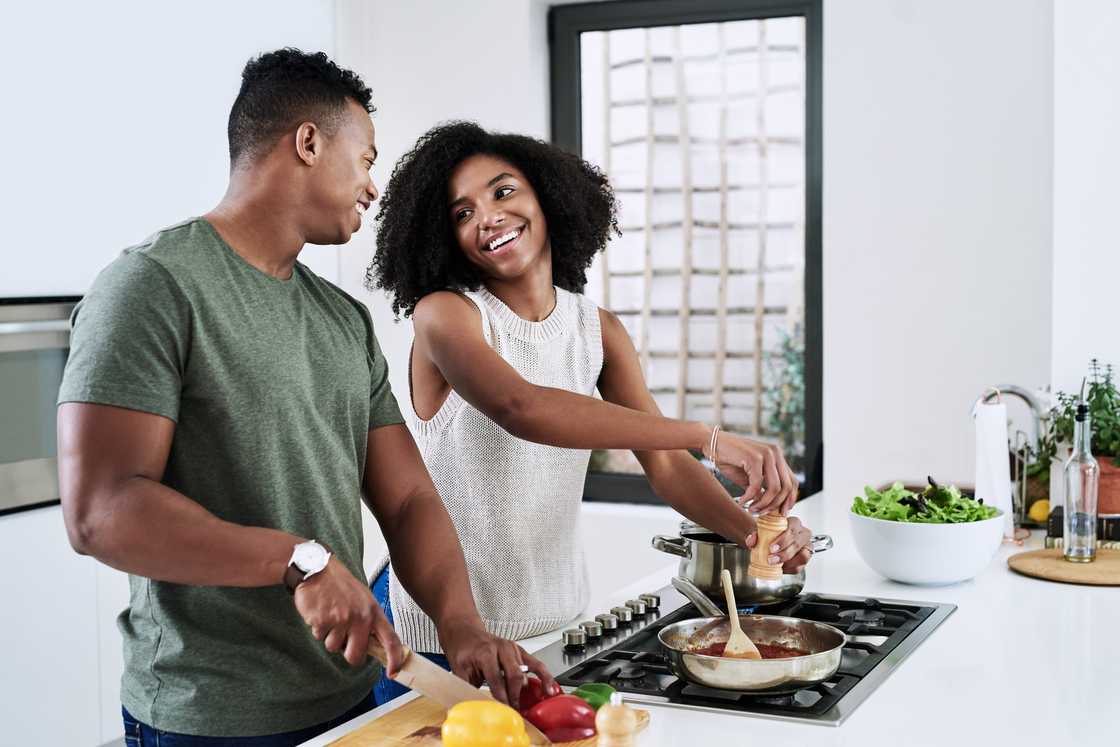 A couple cooks dinner together A couple cooks dinner together