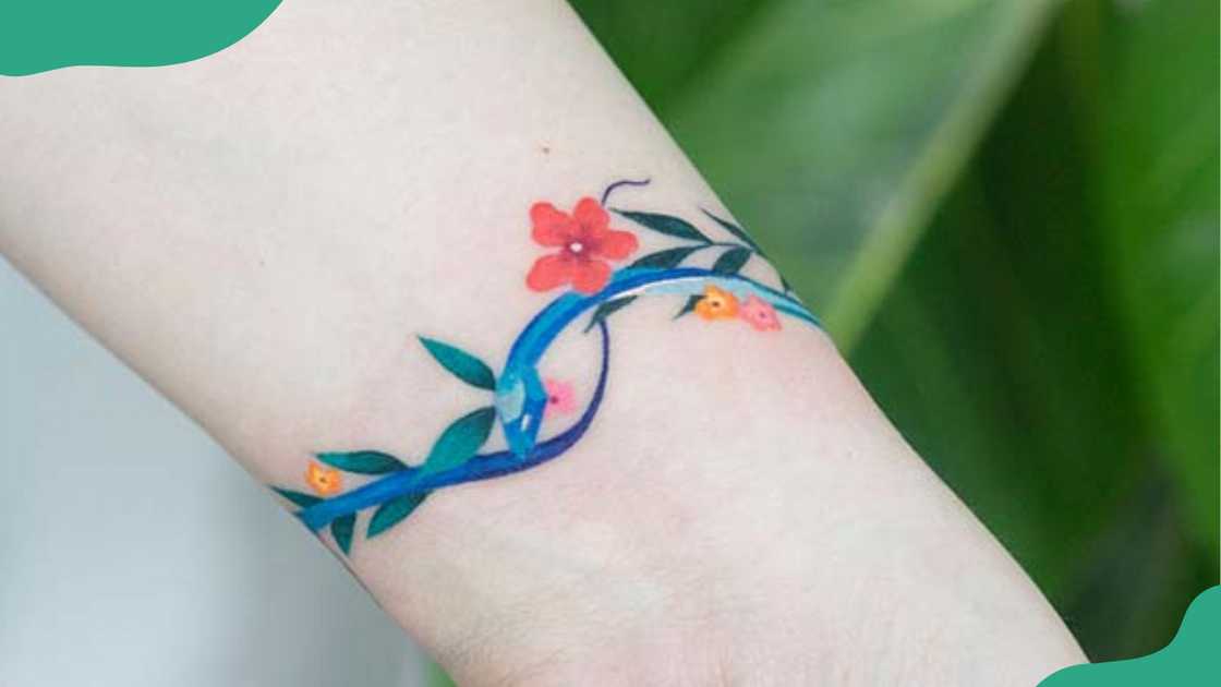 Floral snake wrist tattoos.