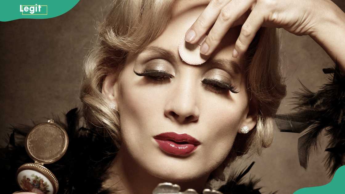 Young woman powdering her face Young woman powdering her face