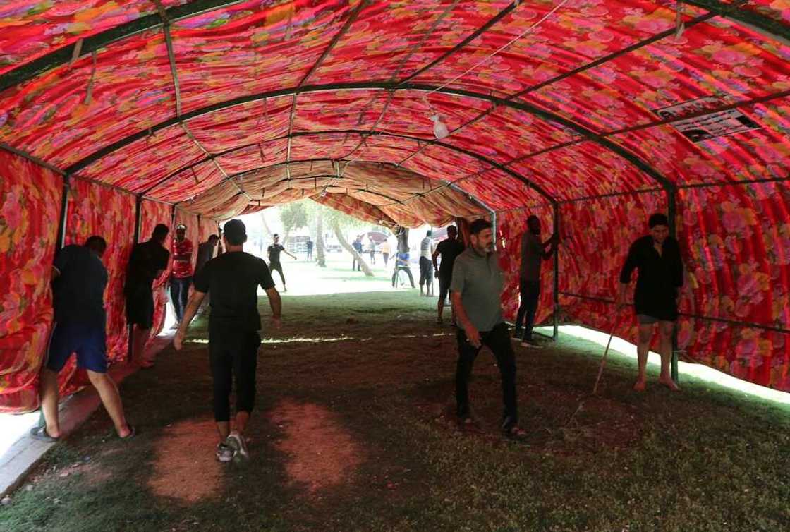 Supporters of Iraq's pro-Iran Coordination Framework set up a tent on a bridge leading to the capital Baghdad's Green Zone Supporters of Iraq's pro-Iran Coordination Framework set up a tent on a bridge leading to the capital Baghdad's Green Zone