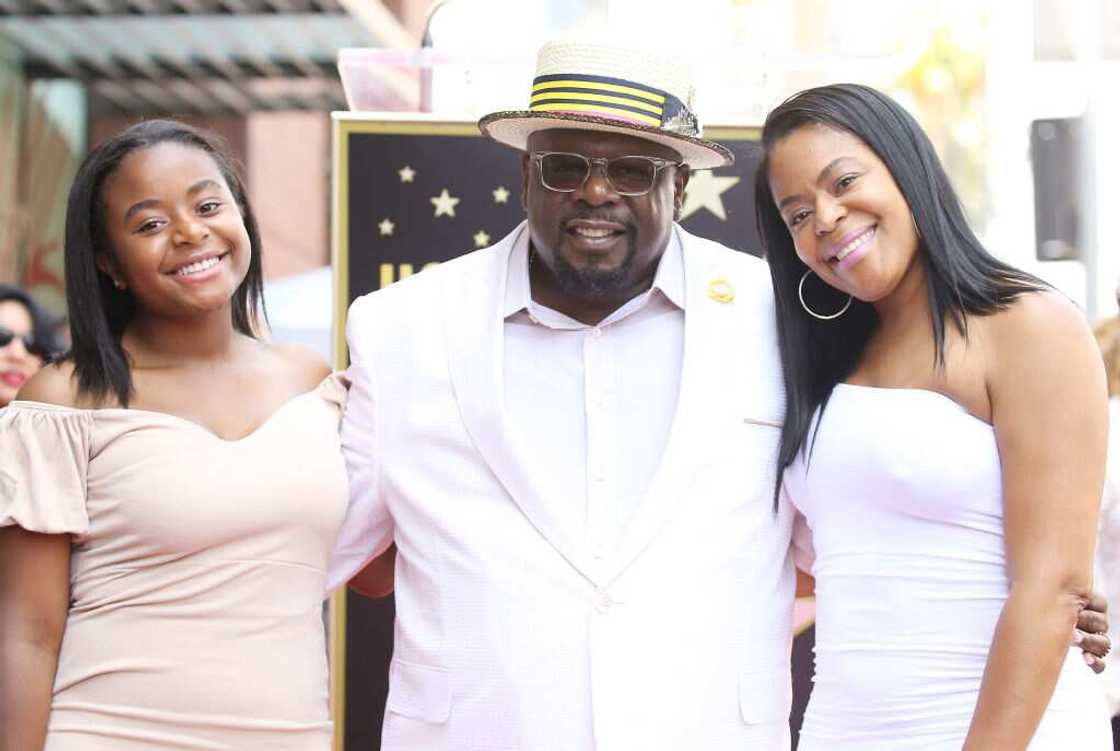 Cedric the Entertainer (C) flanked by his daughter and wife Cedric the Entertainer (C) flanked by his daughter and wife