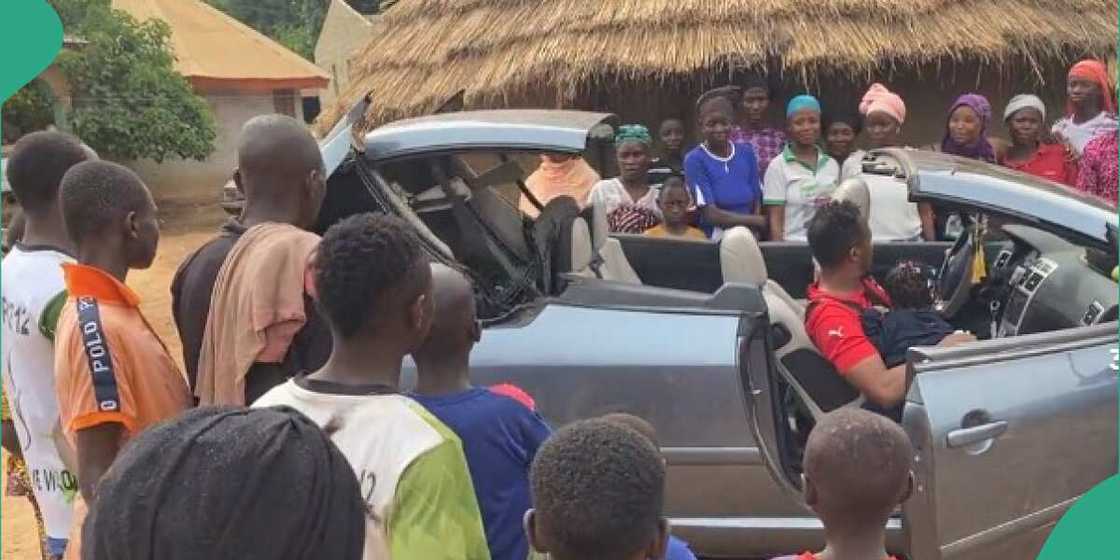 Man storms his village in open-top car Man storms his village in open-top car