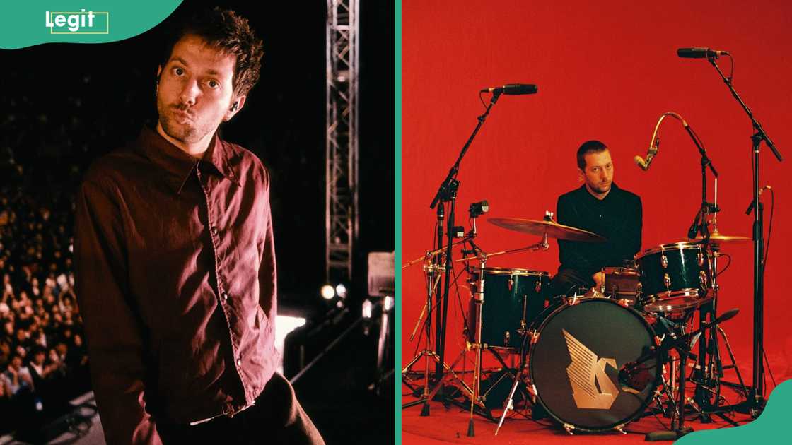 Josh Conway standing onstage in front of a cheering crowd and sitting behind a full drum kit