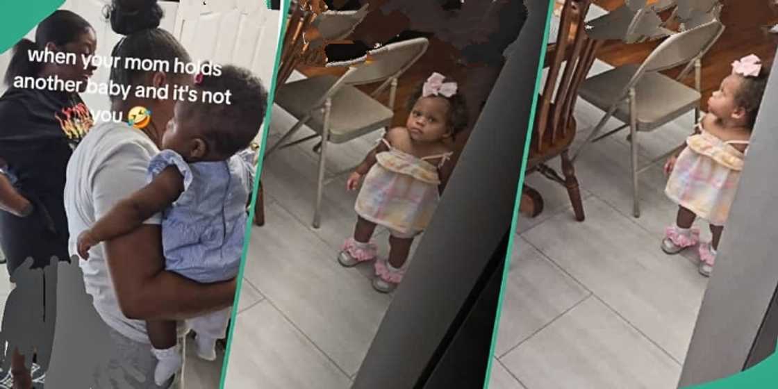 Little girl gives mum heavy side eyes for carrying another child Little girl gives mum heavy side eyes for carrying another child