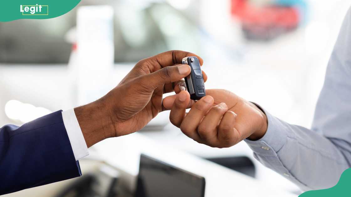 Two hands pictured exchanging car keys