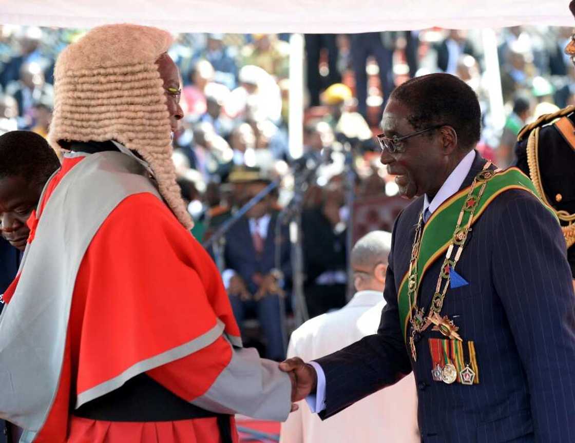 Britain's relations with Zimbabwe went downhill after Mugabe, seen here at a post-election inauguration ceremony in 2013, cracked down on dissent and seized land from white farmers Britain's relations with Zimbabwe went downhill after Mugabe, seen here at a post-election inauguration ceremony in 2013, cracked down on dissent and seized land from white farmers