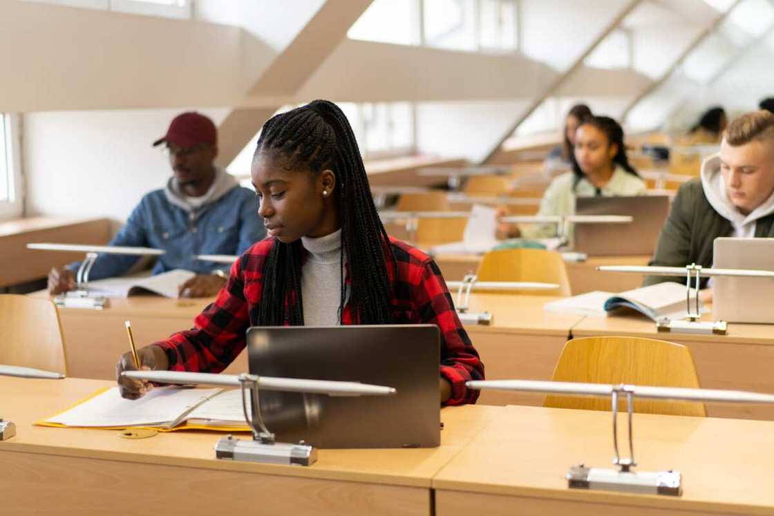 A young lady writing her exams A young lady writing her exams