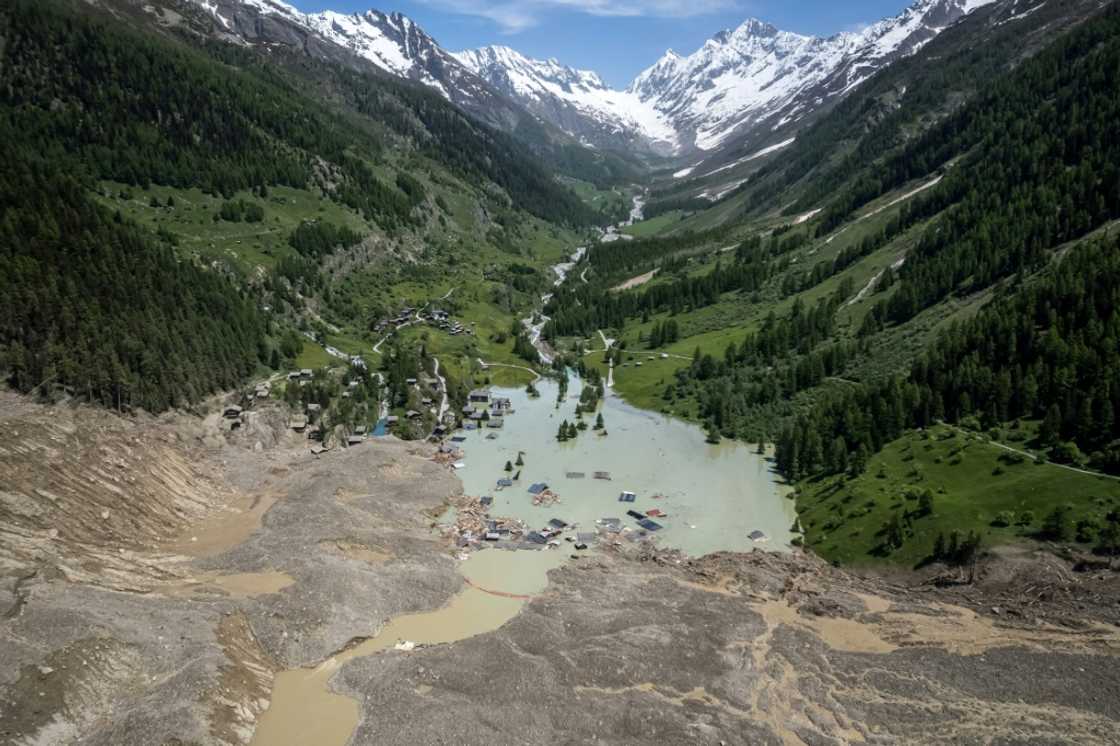 The debris from the collapsed glacier dammed a river, submerging the village of Blatten The debris from the collapsed glacier dammed a river, submerging the village of Blatten