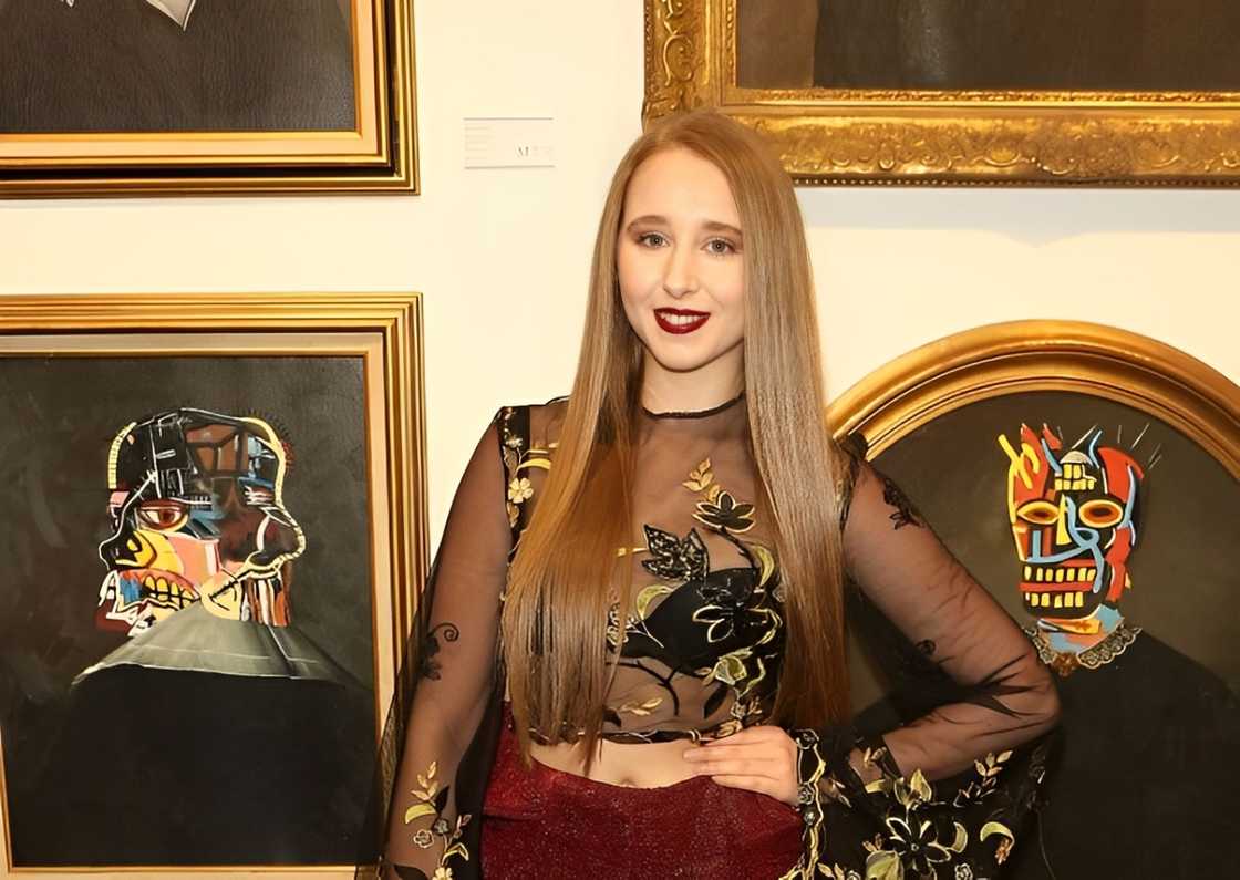 Afton Mckeith poses at a private view of "Keep Smiling", a new exhibition by Mr Brainwash, at Maddox Gallery