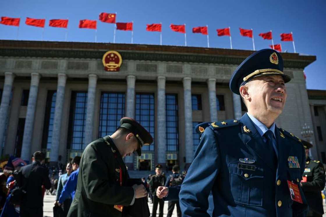 Delegates react after the closing ceremony of the 20th Communist Party Congress at the Great Hall of the People in Beijing