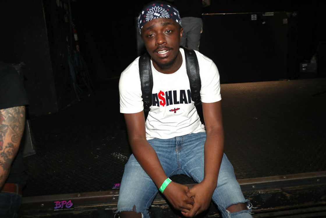 Rapper Tate Kobang poses backstage before a performance Rapper Tate Kobang poses backstage before a performance