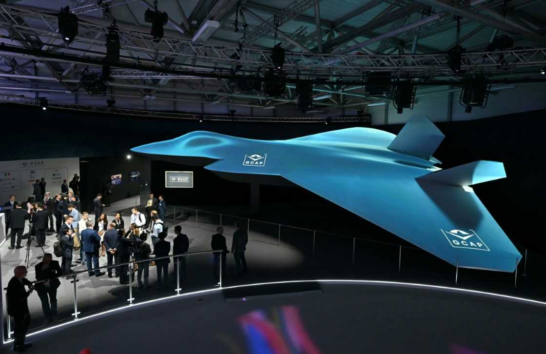 Delegates look at the Global Combat Air Programme (GCAP) 6th generation fighter jet concept design at the Farnborough International Airshow 2024 Delegates look at the Global Combat Air Programme (GCAP) 6th generation fighter jet concept design at the Farnborough International Airshow 2024