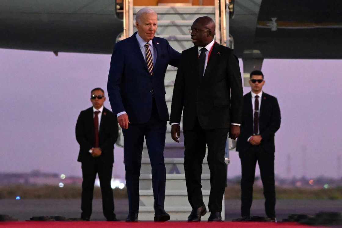 US President Joe Biden (3rd R) met with Angolan Foreign Affairs Minister Tete Antonio (2nd R) upon his arrival in Luanda