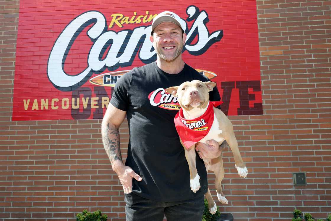 TikTok animal welfare activist Lee Asher accepts q cheque from Raising Cane’s for the Asher House nonprofit at Raising Cane's in Vancouver, Washington TikTok animal welfare activist Lee Asher accepts q cheque from Raising Cane’s for the Asher House nonprofit at Raising Cane's in Vancouver, Washington