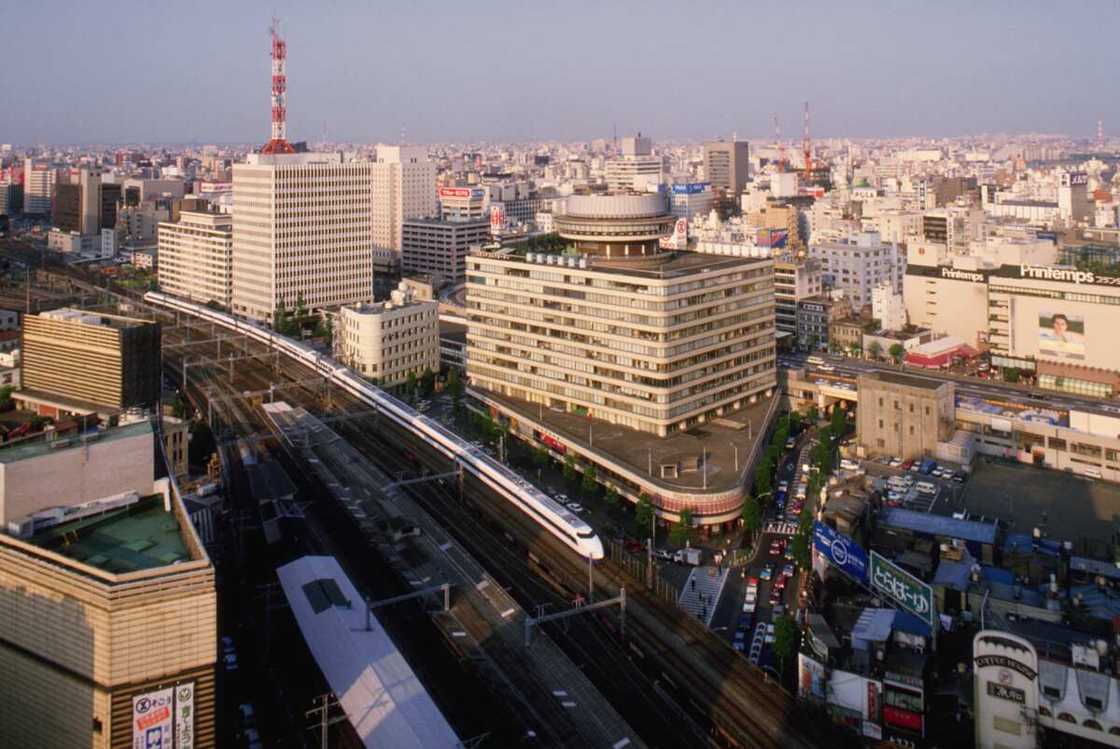 A bullet train passing through a city in Japan