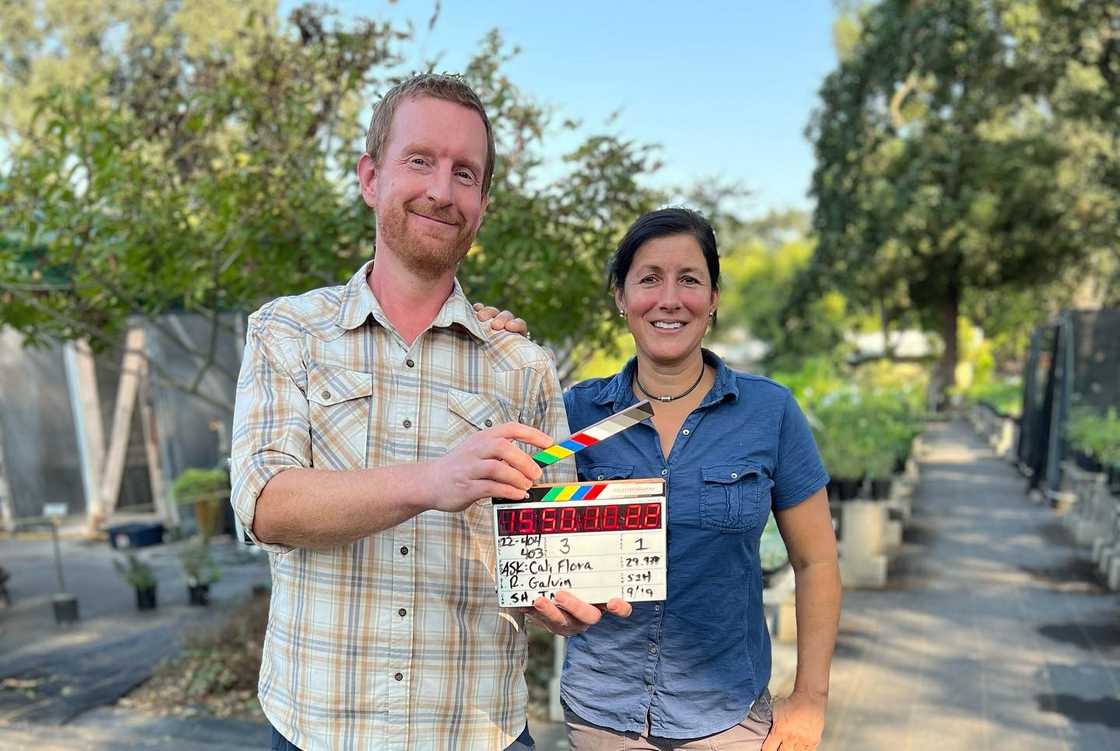 Jenn Nawada and the ssistant director st​and out‍doors in a nurse⁠ry setting during produc‍tio‌n.