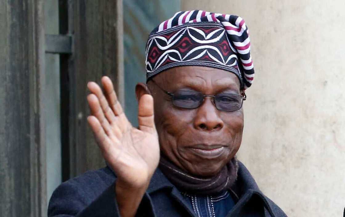 Former Nigerian President Olusegun Obasanjo waves at Elysee Presidential Palace