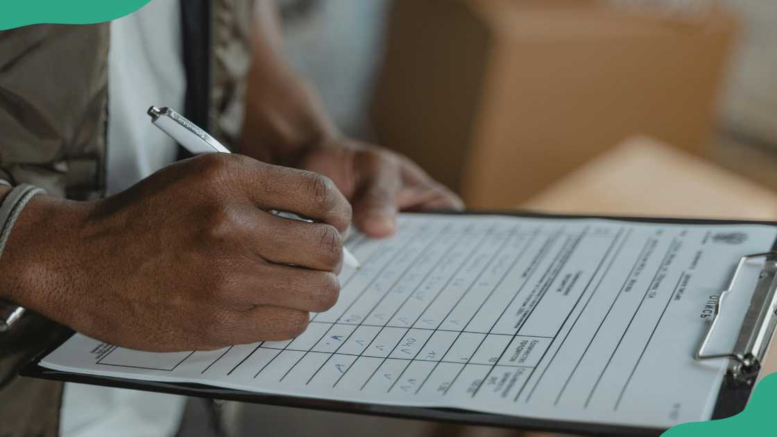 A person filling a form A person filling a form