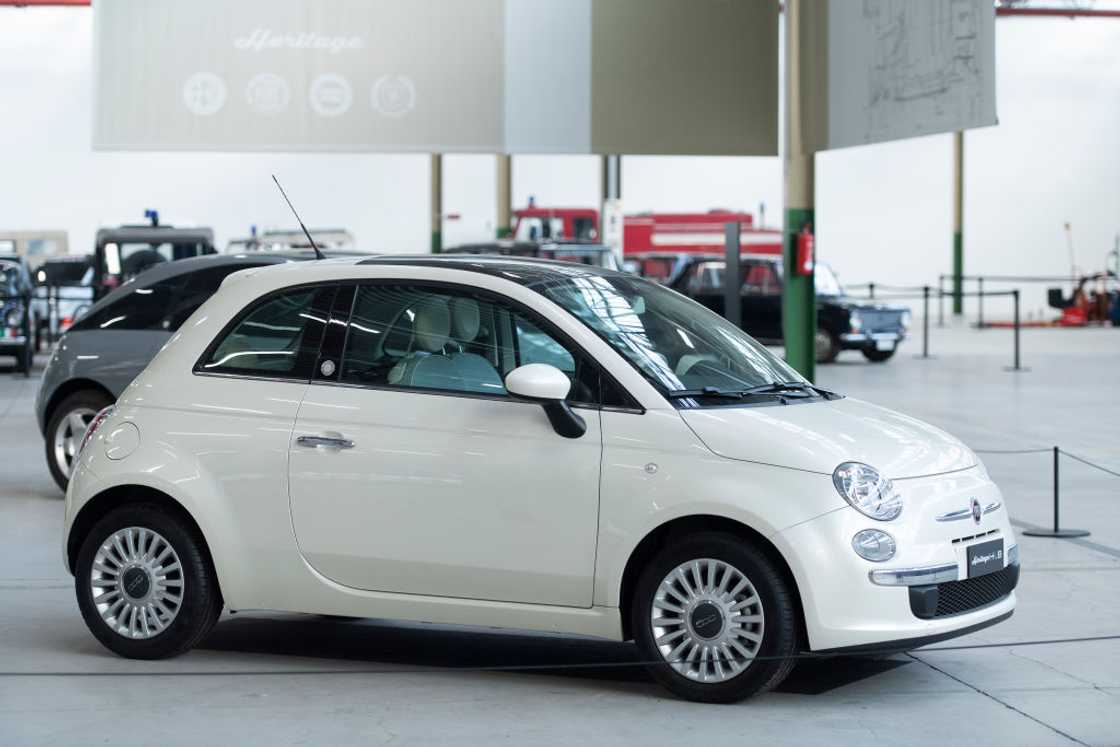 A white Fiat 500 car parked A white Fiat 500 car parked