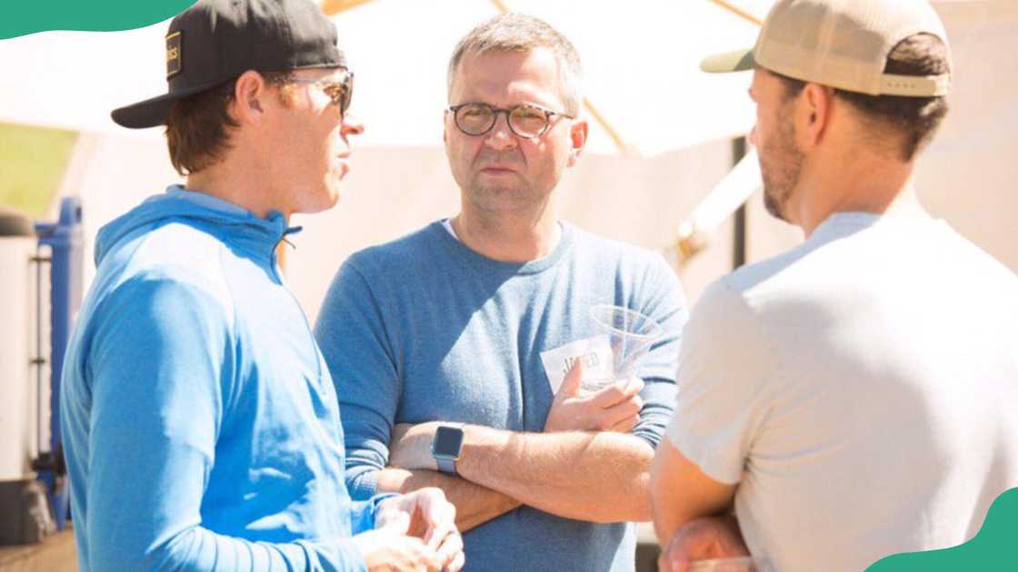 Ryan Smith's brother having a conversation with two people