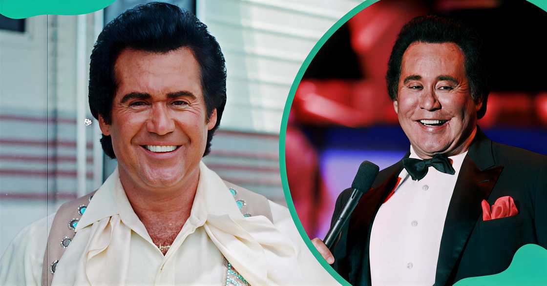 Wayne Newton poses standing. The singer sings on stage in a tuxedo. Wayne Newton poses standing. The singer sings on stage in a tuxedo.