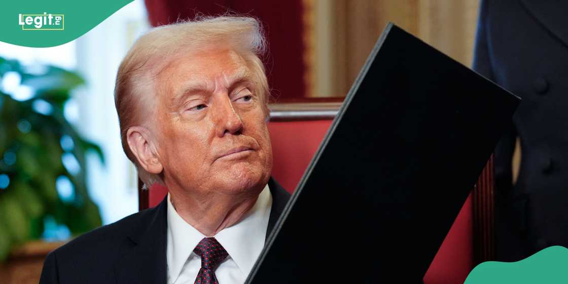 Donald Trump handles a signed order Donald Trump handles a signed order