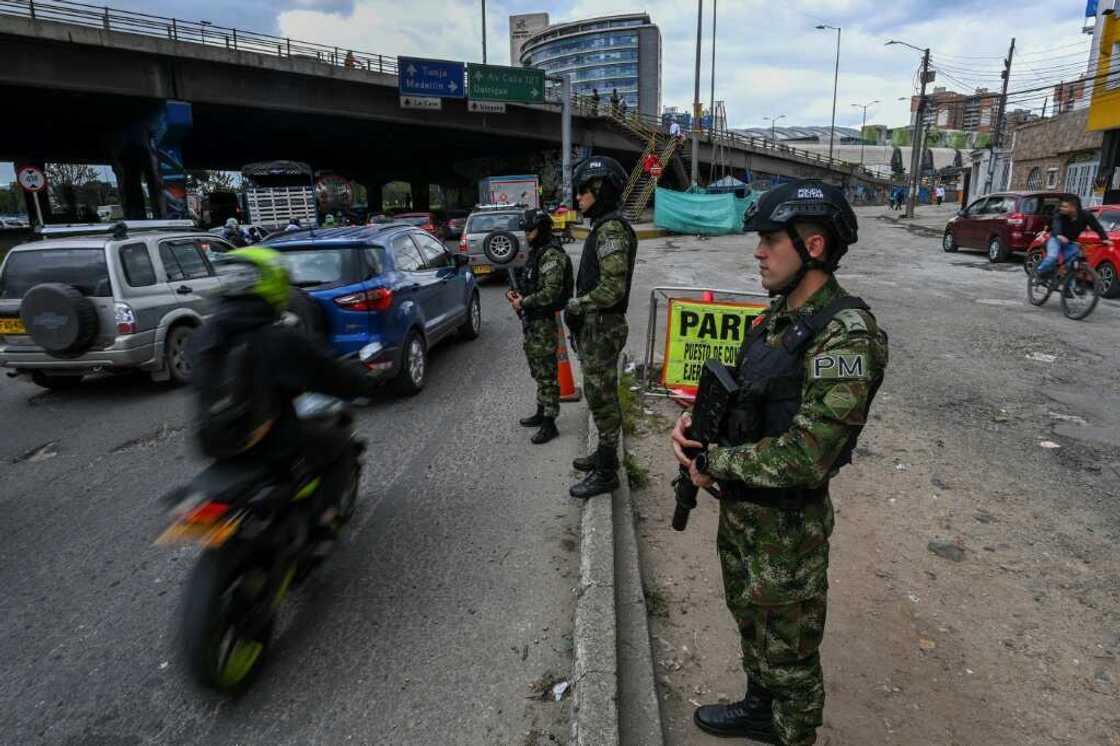 Soldiers stand guard at a checkpoint on a road entering Bogota, on June 18, 2022, a day before the presidential runoff election Soldiers stand guard at a checkpoint on a road entering Bogota, on June 18, 2022, a day before the presidential runoff election