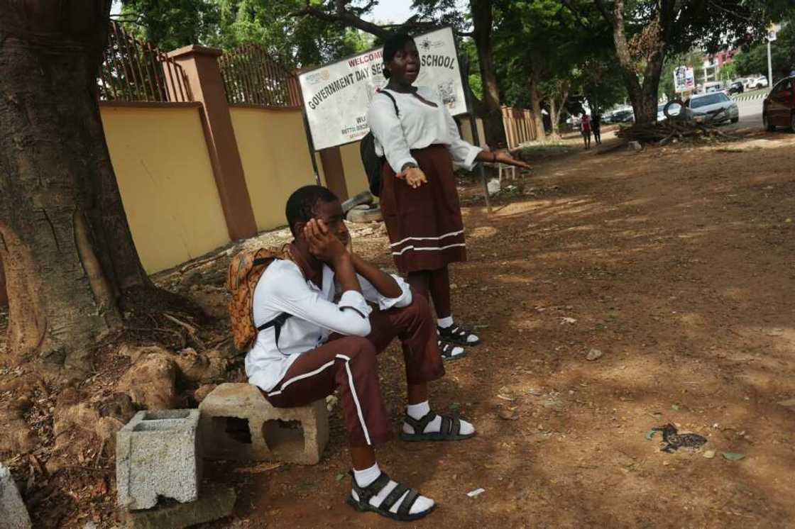 Students wait outside their Government Science Secondary School in the capital after unions launched an indefinite strike for a higher minimum wage