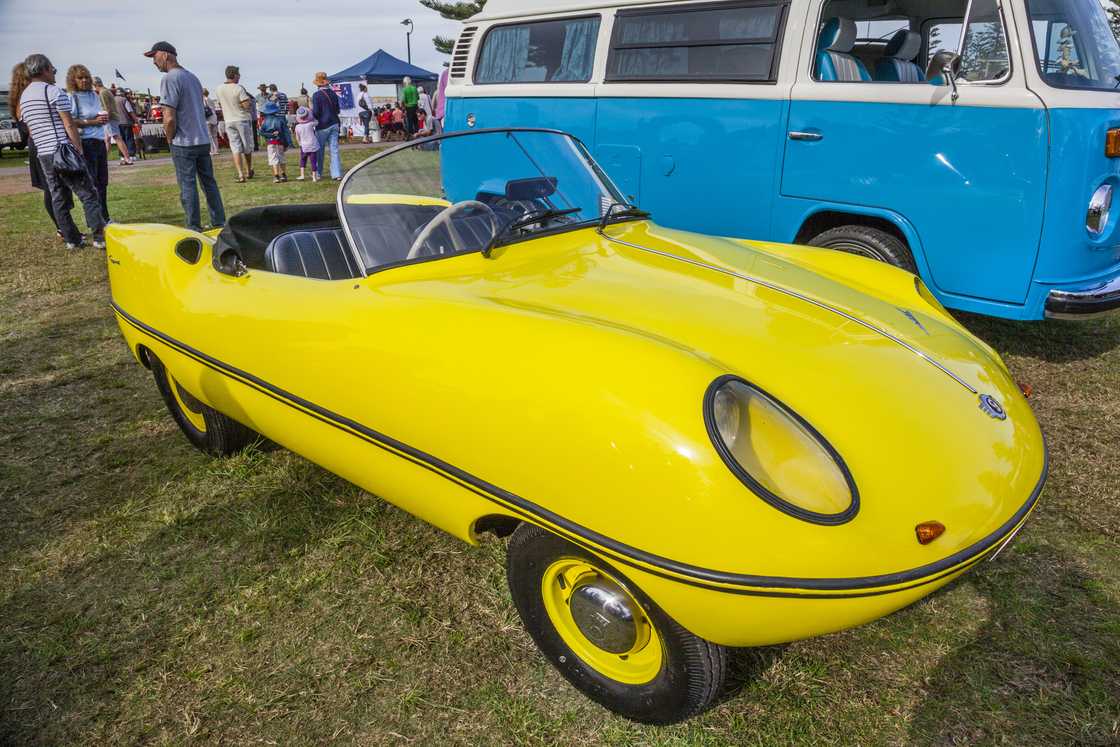 A yellow Goggomobil Dart microcar on display A yellow Goggomobil Dart microcar on display