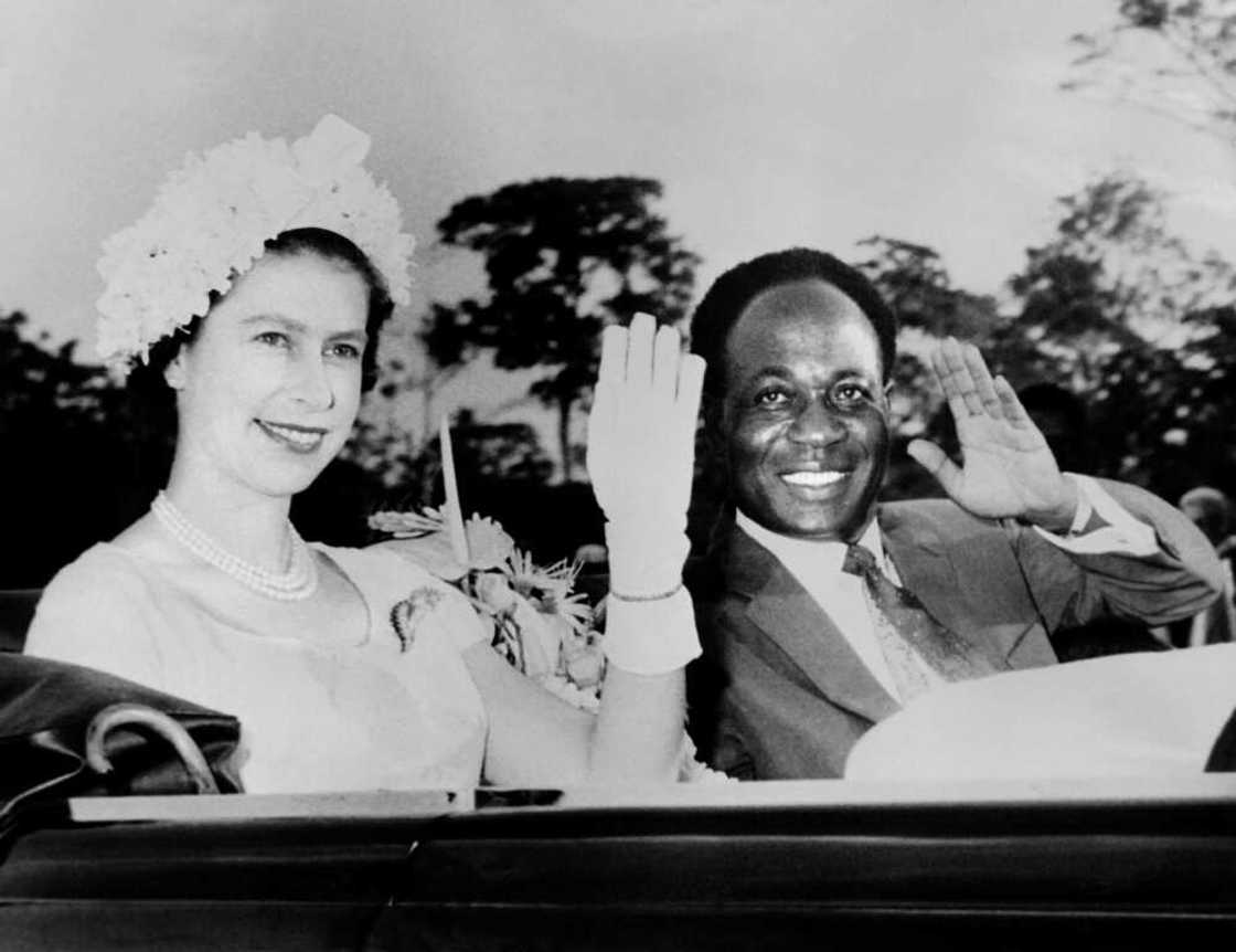 The queen and Ghana's first post-independence president, Kwame Nkrumah, wave to the crowd during a royal visit in 1961