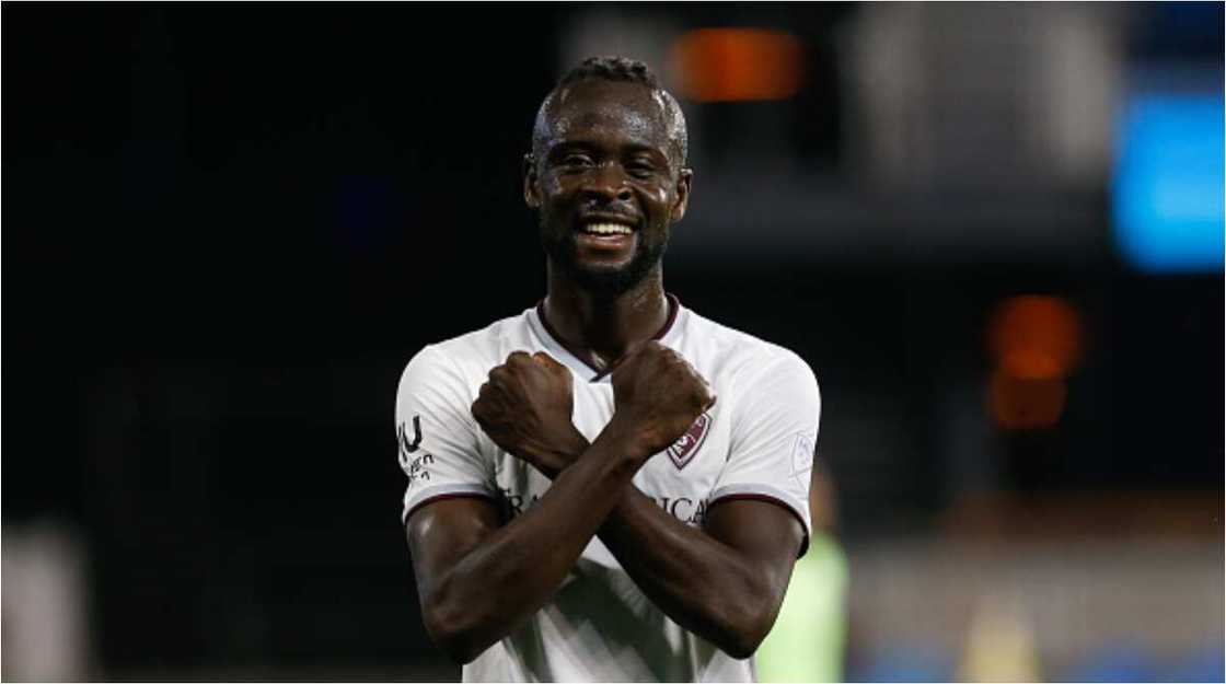 Sierra Leonean striker who scored 2 goals against Nigeria alights from car to play with a group of local children Sierra Leonean striker who scored 2 goals against Nigeria alights from car to play with a group of local children