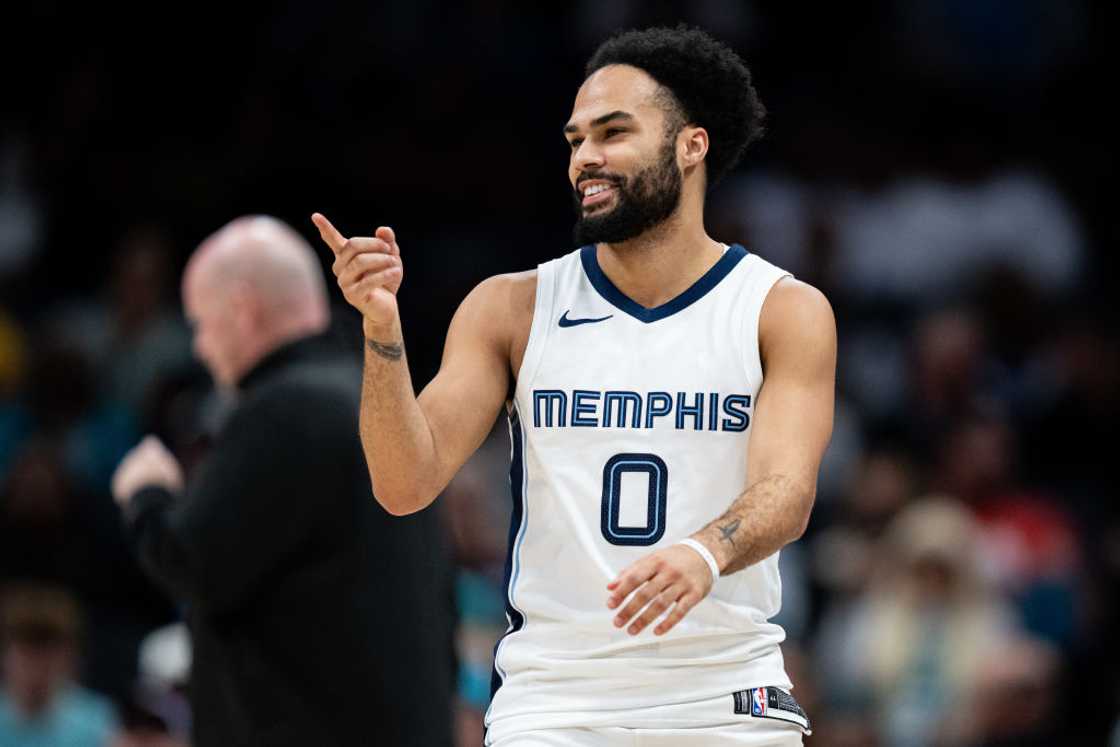 Jacob Gilyard smiles during an NBA game