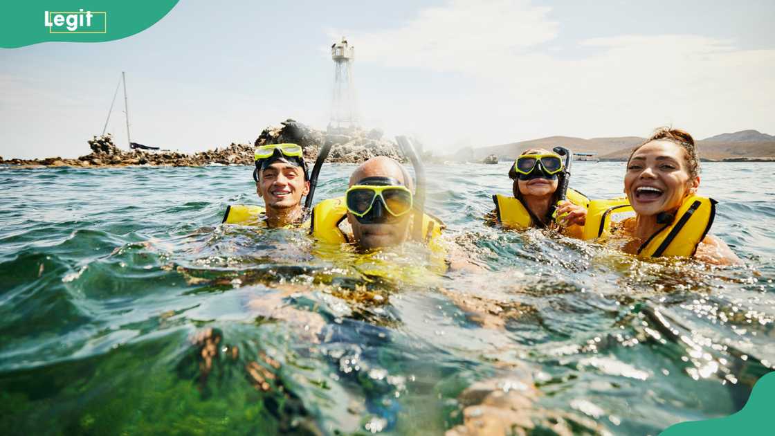 Young people on snorkeling tour in tropical ocean while on vacation Young people on snorkeling tour in tropical ocean while on vacation