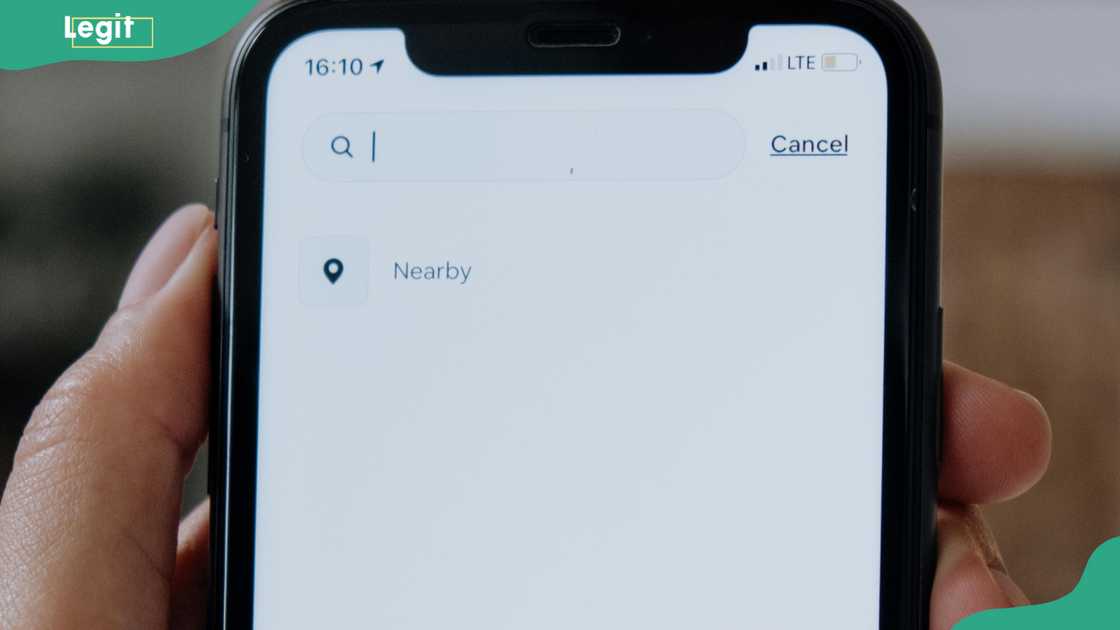 Someone holding a phone searching for location Someone holding a phone searching for location